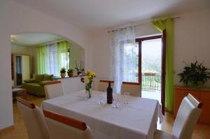a dining room with a table with wine glasses at Garden Apartment Maria in Vrsar