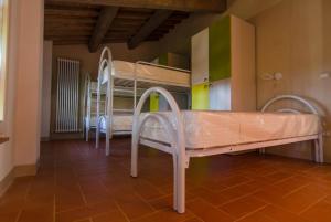Postel nebo postele na pokoji v ubytování Ostello San Miniato