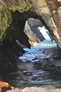 a painting of a river under a bridge at Dolphin Hotel in Inishbofin