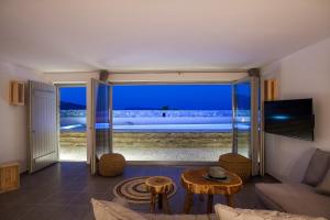 a living room with a view of the ocean at Myconian Platinum Villas in Kalafatis