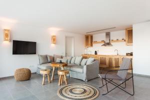 a living room with a couch and a table at Myconian Platinum Villas in Kalafatis