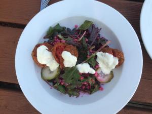 a white plate with a salad with food on it at Dolphin Hotel in Inishbofin