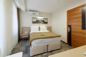 A bed or beds in a room at Nishant Hotel