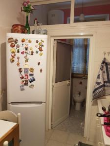 a refrigerator with magnets on it in a kitchen at Robta's Dream Home in Rome