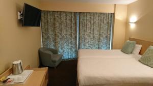 a hotel room with two beds and a window at Residence Club Inn in Nice