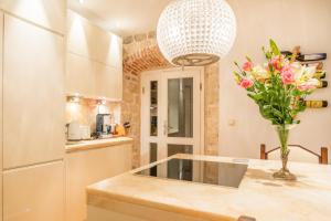 a kitchen with a vase of flowers on a counter at Imperial Luxury Apartment in Split