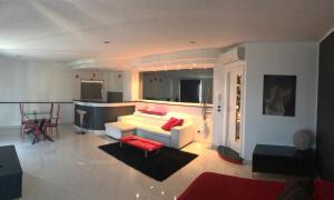 a living room with a white couch and red pillows at Prestige Loft Taormina in Taormina