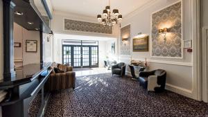 sala de estar con sofás, mesa y sillas en The Royal Hotel en Bideford