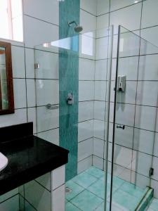 a bathroom with a shower with a glass door at B12 Cowrie Beach Studio Apartment in Bamburi