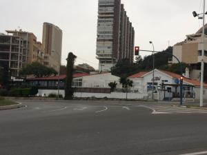 an empty city street with a traffic light and buildings at First line Apartment in Alicante