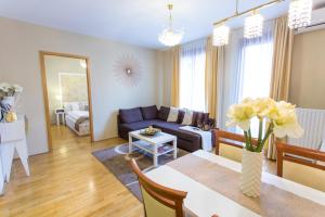 a living room filled with furniture and a table at Colours Apartments Budapest in Budapest