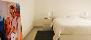 um quarto com uma cama e um quadro na parede em Quinta de Gildinho em Gildinho