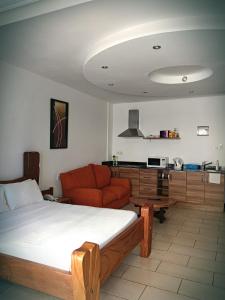 a living room with a bed and a couch at B12 Cowrie Beach Studio Apartment in Bamburi