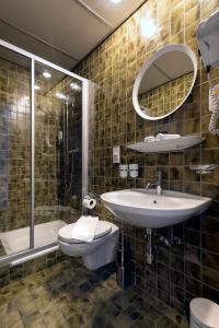 a bathroom with a sink and a toilet and a shower at Hotel Croce Federale in Bellinzona