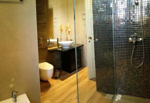 a bathroom with a toilet and a sink and a shower at Funchal Apartament Marina View with PARKING FREE in Funchal +27 photos