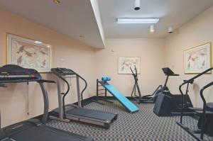 a gym with treadmills and exercise equipment in a room at Tiki Resort - Lake George in Lake George