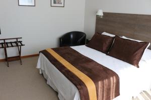 Postel nebo postele na pokoji v ubytování Conrado Hotel Osorno
