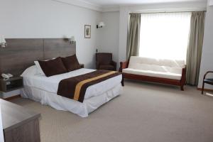 Postel nebo postele na pokoji v ubytování Conrado Hotel Osorno