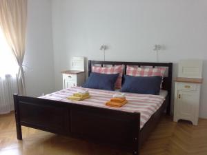 a bedroom with a large bed with two towels on it at Your Ljubljana Home in Ljubljana