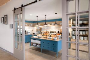 a kitchen with a blue island with food on it at Country Inn & Suites by Radisson, Houghton, MI in Houghton