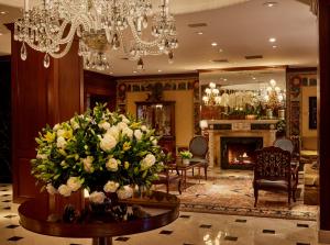 a lobby with a table with a large bouquet of flowers at The Townsend Hotel in Birmingham