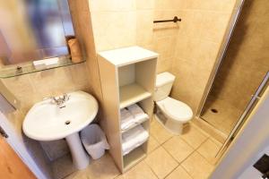 a small bathroom with a sink and a toilet at Auberge le St-Georges in Saguenay +26 photos