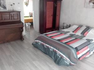a bedroom with a bed and a dresser and a dog at Gîte du lion90 in Belfort