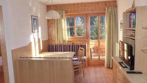 a living room with a table and a window at Lucknerhof in Kals am Großglockner