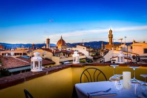 a view of a city from a balcony with a table at Hotel La Scaletta al Ponte Vecchio in Florence