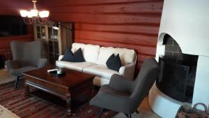 ein Wohnzimmer mit weißem Sofa und Kamin in der Unterkunft Bjerkeløkkja Bed and Breakfast in Oppdal