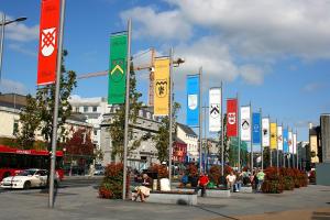 a row of colorful signs on a city street at Skeffington Arms Hotel in Galway