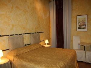 Postel nebo postele na pokoji v ubytování Anfiteatro B&B