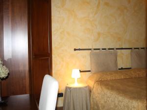 Postel nebo postele na pokoji v ubytování Anfiteatro B&B