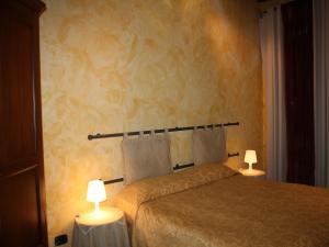 Postel nebo postele na pokoji v ubytování Anfiteatro B&B