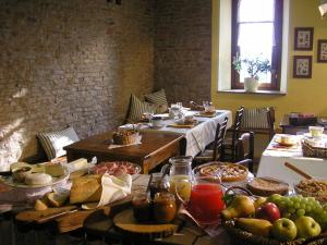 a table with many plates of food on it at Casa Branzele in Trezzo Tinella