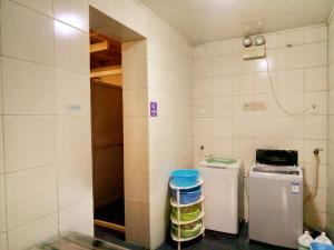 a kitchen with two small refrigerators in a room at Qianmen Hostel (Beijing Tian'anmen Dashilan) in Beijing