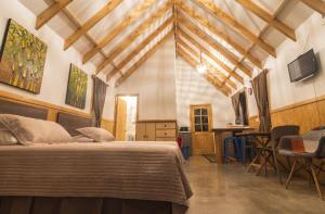 a bedroom with a bed and a table and chairs at Pacific Bungalows in Hanga Roa