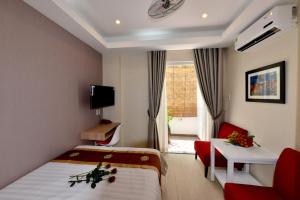 a hotel room with a bed and a table and a window at Phu My Hung - Saigon South Serviced Apartments - Near Vivo City Mall in Ho Chi Minh City