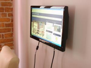 a computer monitor is hooked up to a wall at Split Artistic Apartments in Split