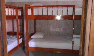 a couple of bunk beds in a room at Ratih Bali Hostel in Denpasar