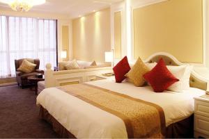 a hotel room with a large bed with red pillows at Central Hotel Shanghai in Shanghai
