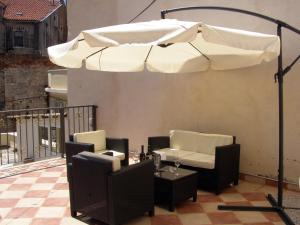 a white umbrella sitting on top of a balcony at Split Artistic Apartments in Split