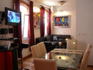 a living room with a couch and a television at Split Artistic Apartments in Split