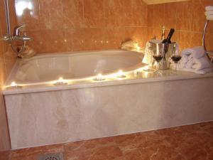 a bath tub with candles and wine glasses in a bathroom at Split Artistic Apartments in Split +37 photos