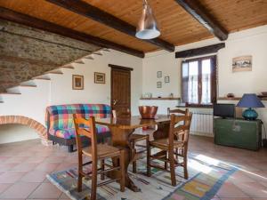 a living room with a table and chairs and a couch at Private pool Villa Wine&cooking -Trasimeno Lake in Panicale