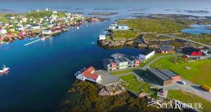 an aerial view of a small village in a harbor at Sula Rorbuer og Havhotell in Sula