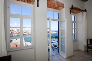 a room with windows and a view of the ocean at Suites Pandora in Chania