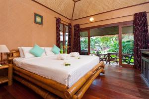 a bedroom with a large bed in a room at Palm Leaf Resort Koh Tao in Ko Tao