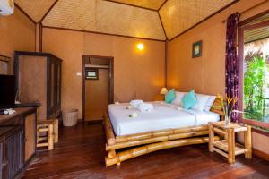 a bedroom with a bed in a room at Palm Leaf Resort Koh Tao in Ko Tao