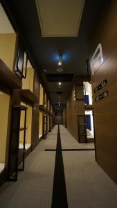 an empty hallway of a building with a long corridor at The Bed and Spa (male only) in Tokorozawa